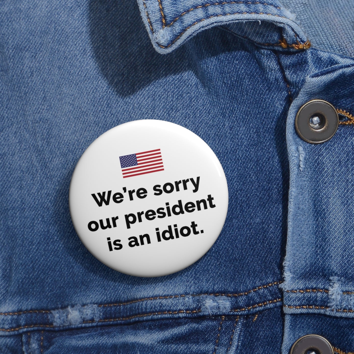 Button: "We're Sorry Our President Is an Idiot," with American Flag